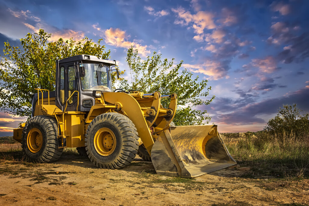 A bulldozer or loader moves the earth at the construction site a